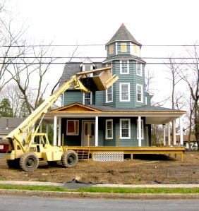 Some original details obscured, but windows in the tower are restored, and the return of the porch makes a huge difference to the presence on the street